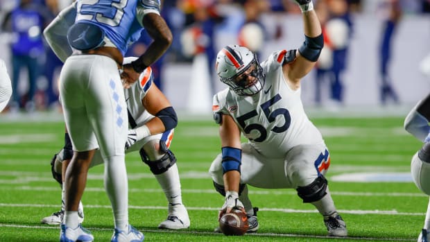 Virginia Cavaliers center Brian Stevens (55) signals a play against the North Carolina Tar Heels in the second half at Kenan Memorial Stadium. 
